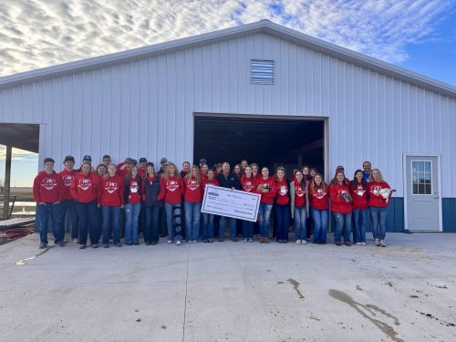 A $15,000 grant from McLean County Farm Bureau is presented to Olympia FFA by Darren Davis, McLean County Farm Bureau Vice President. The funds helped the ag department build a new livestock facility on the school campus.